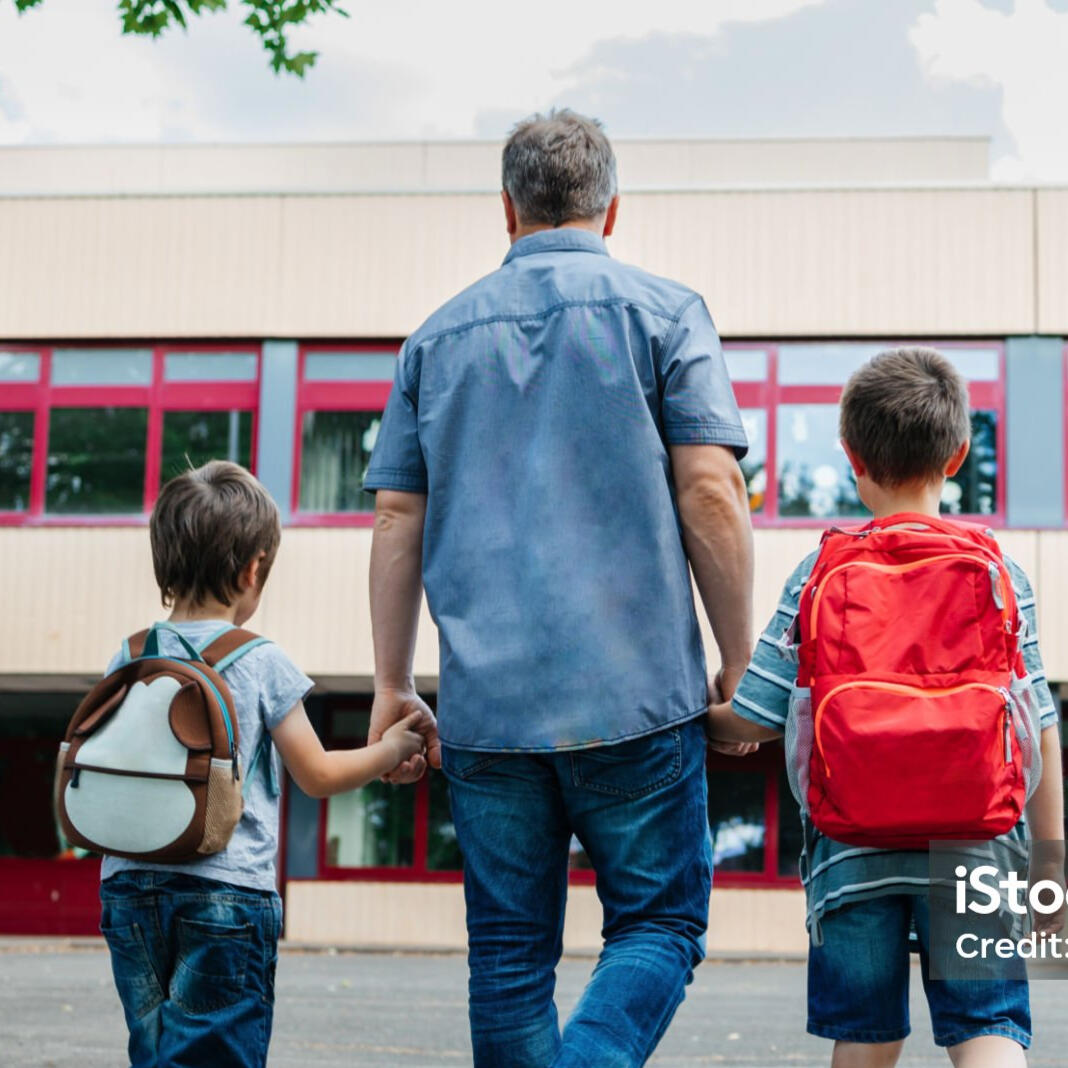 Dad taking kids to school